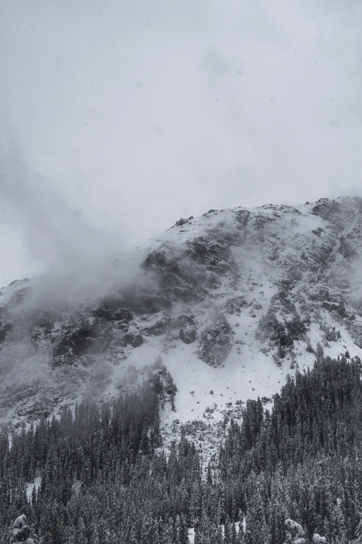 a black and white view of the mountains from the snow