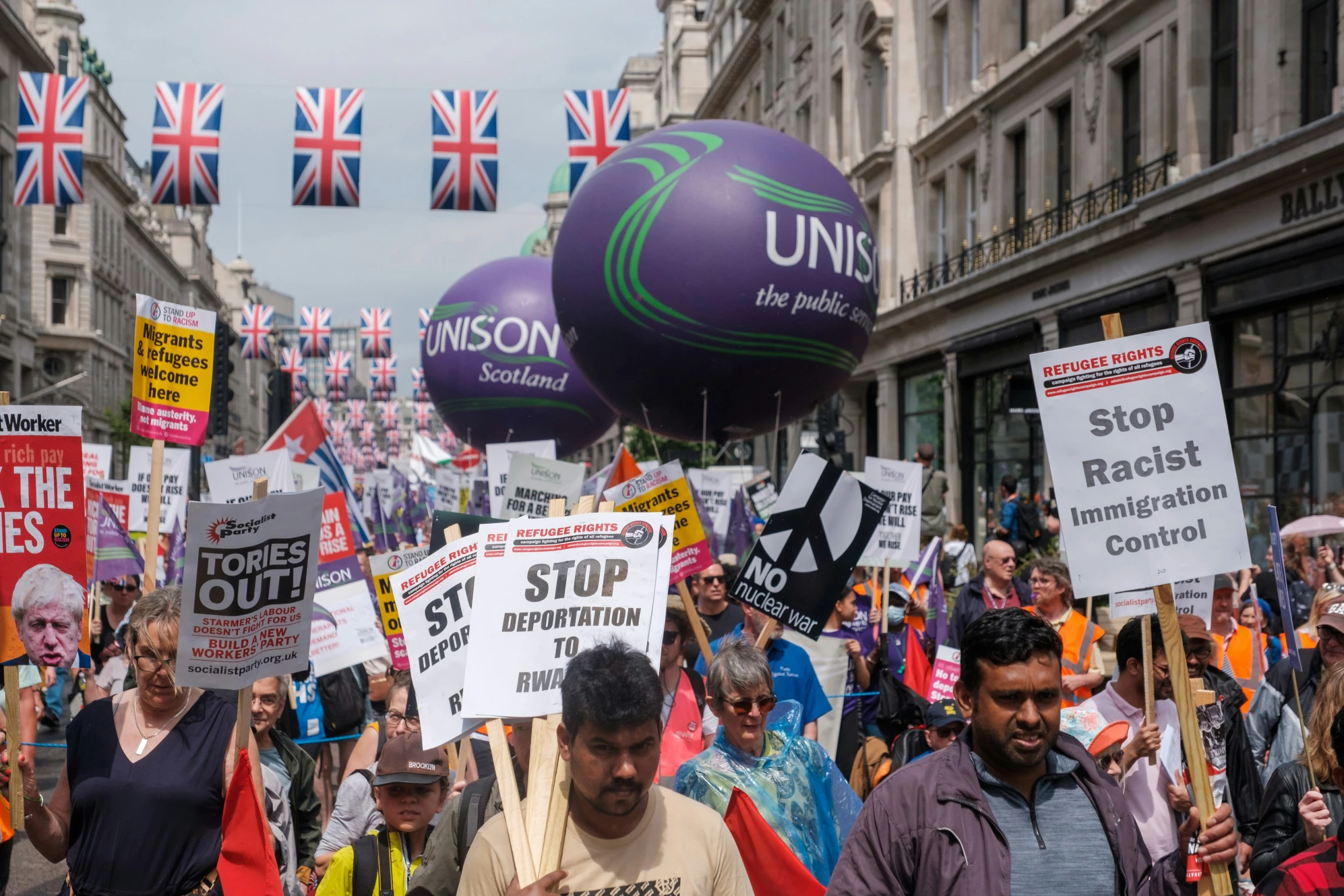 several people holding up signs in protest outside the united kingdom