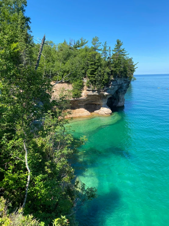 a beautiful blue ocean filled with lots of green trees