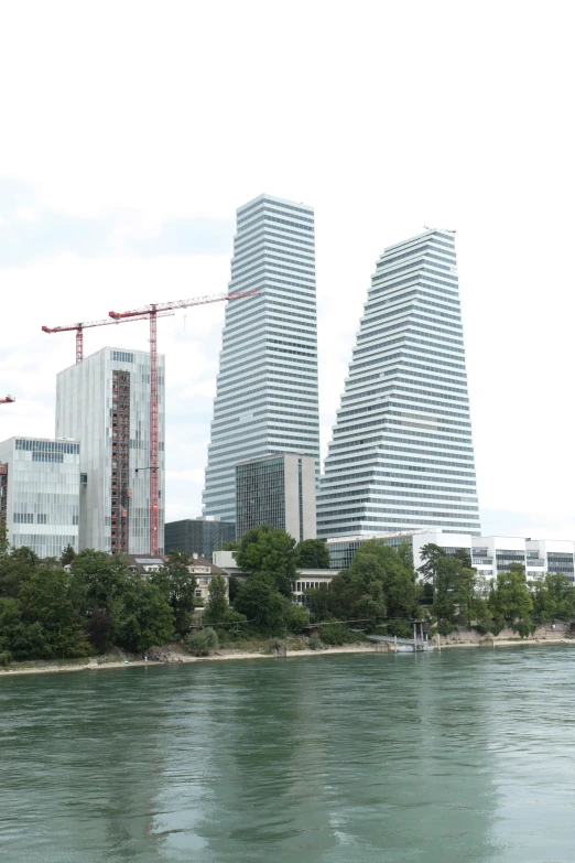 a view of two city buildings next to the water