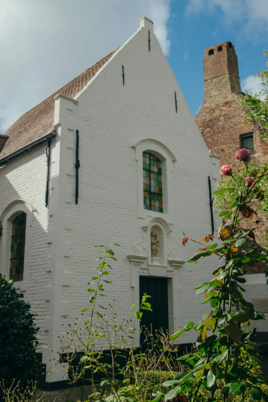 the brick front of the old church with stained glass windows