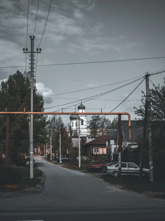 an empty road surrounded by power lines and power lines