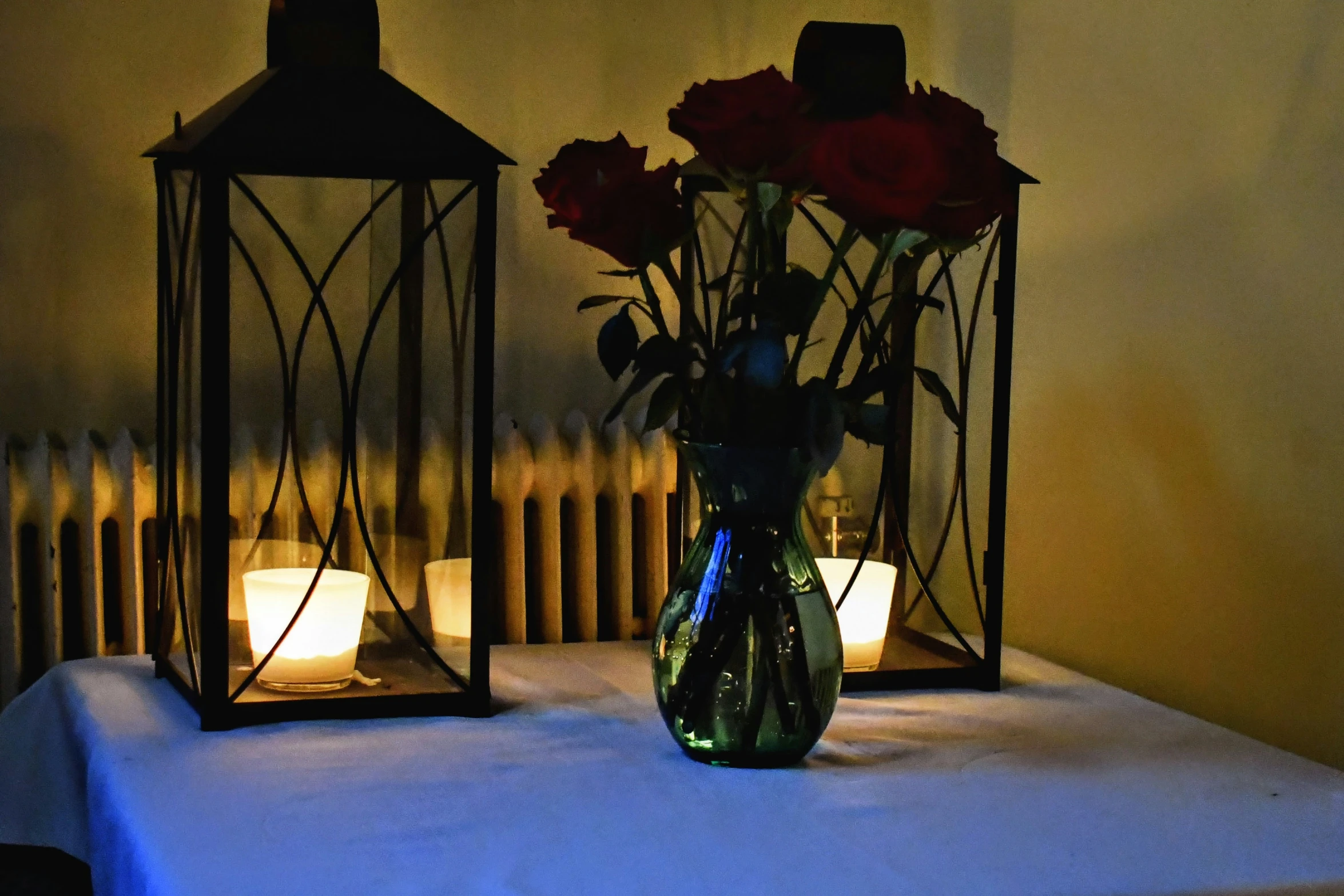 two small lights are sitting on the table near some flowers