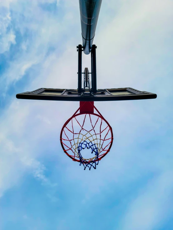 two basketballs are being lifted in the air