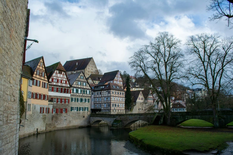 beautiful old buildings line a river in europe