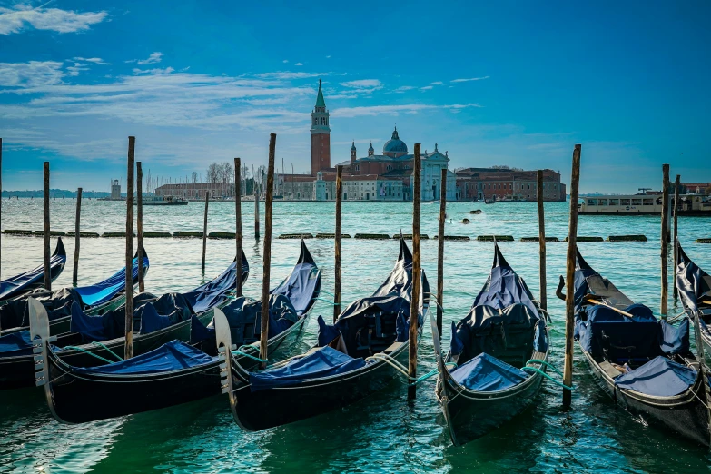 rowboats sit parked on the water in front of buildings