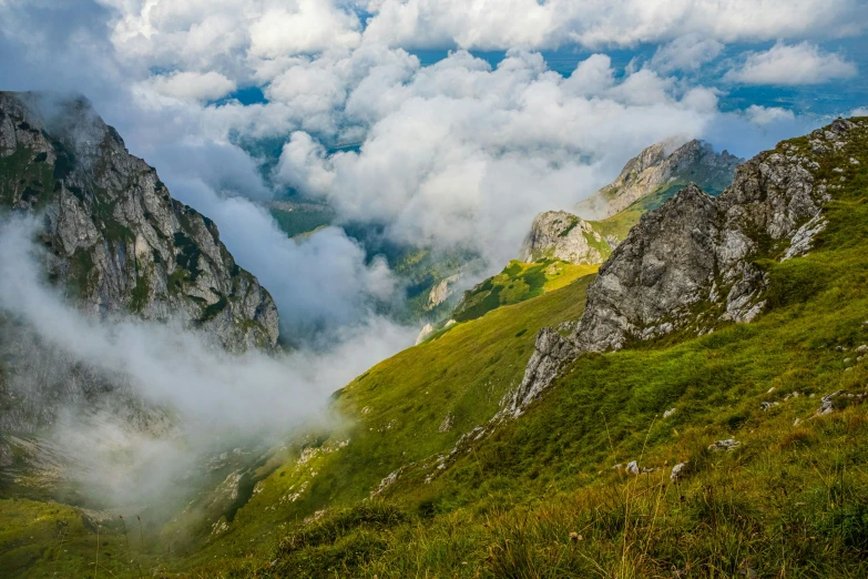 some very tall mountains covered in clouds