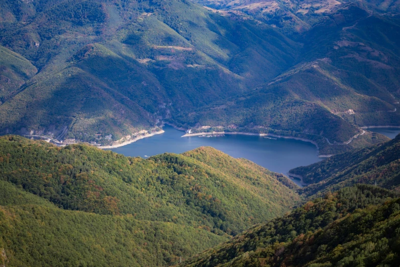 green mountains have a mountain river between them