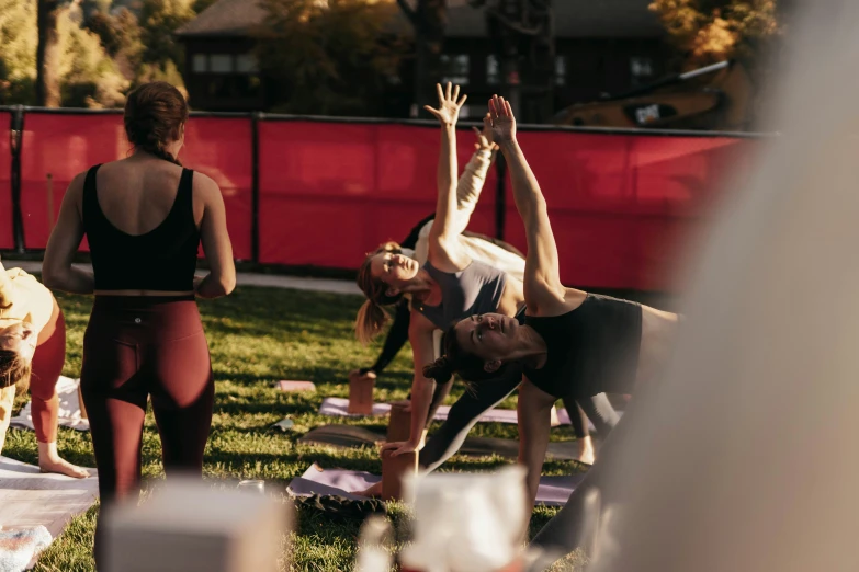 a group of women doing yoga outdoors at night