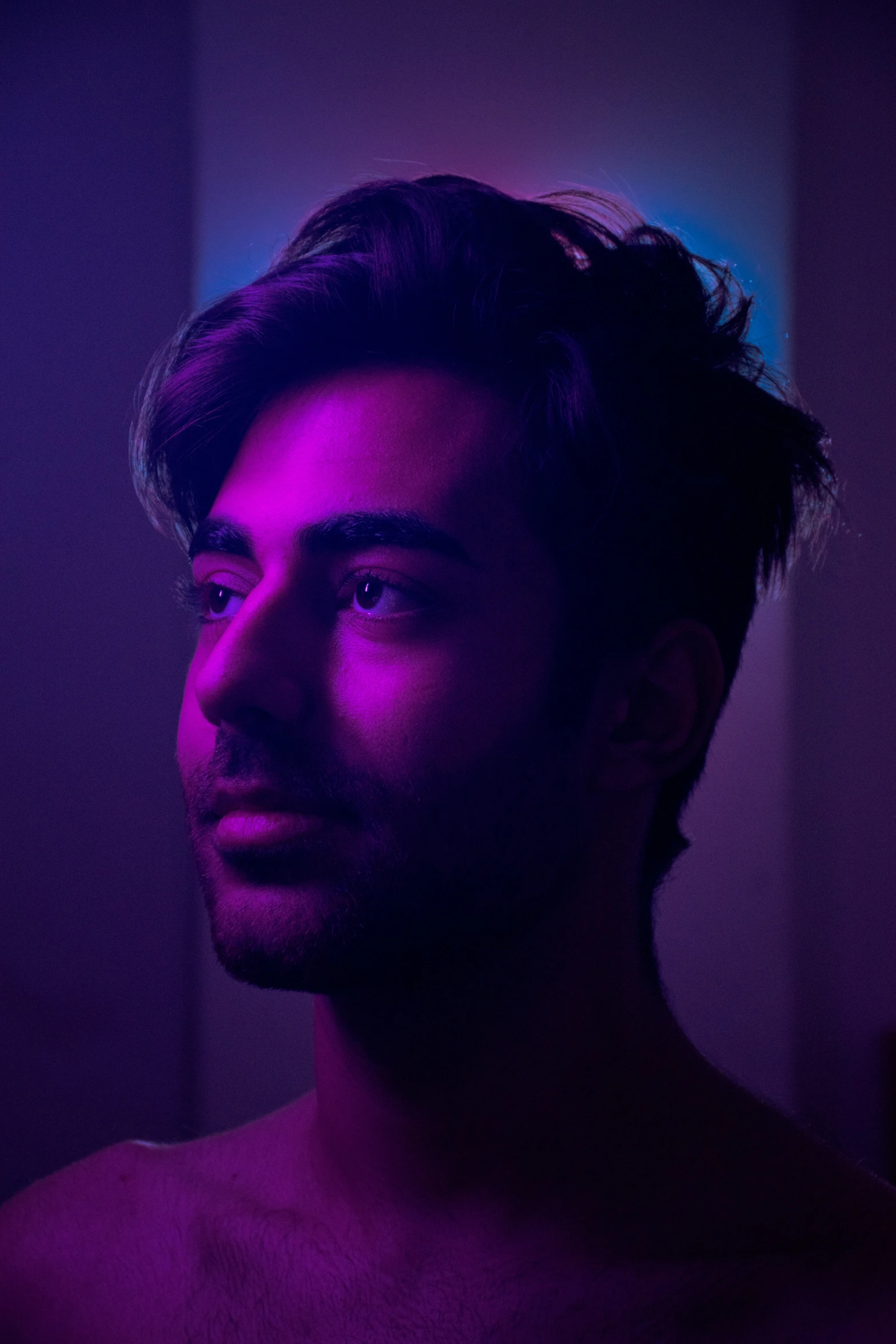 a man in a purple light looking back