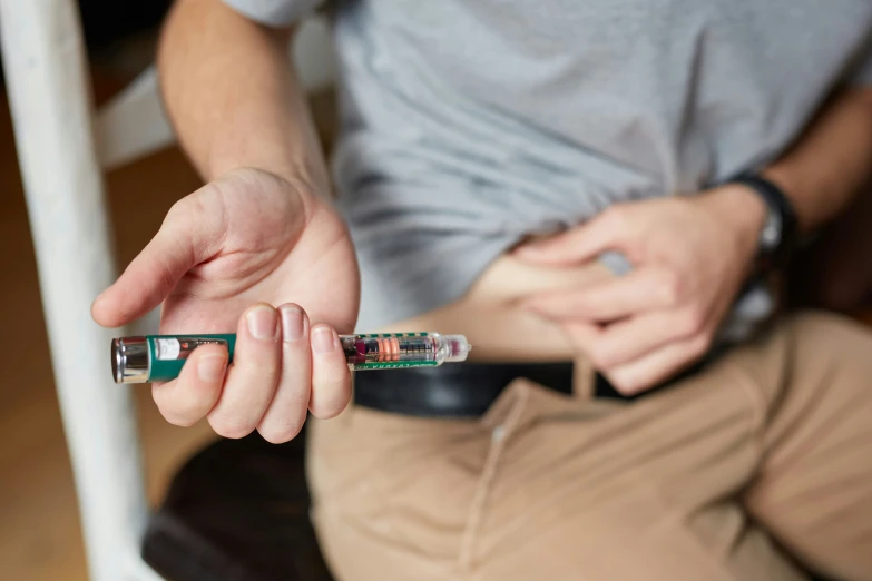 a person holds a syii and a small plastic tube