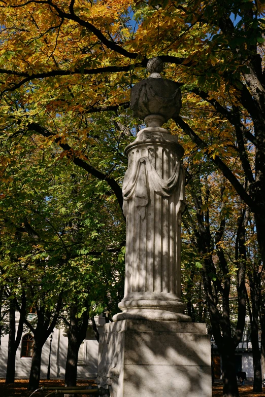 there is a statue of an old woman in a public park