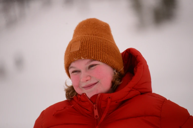 there is a young woman in the snow smiling