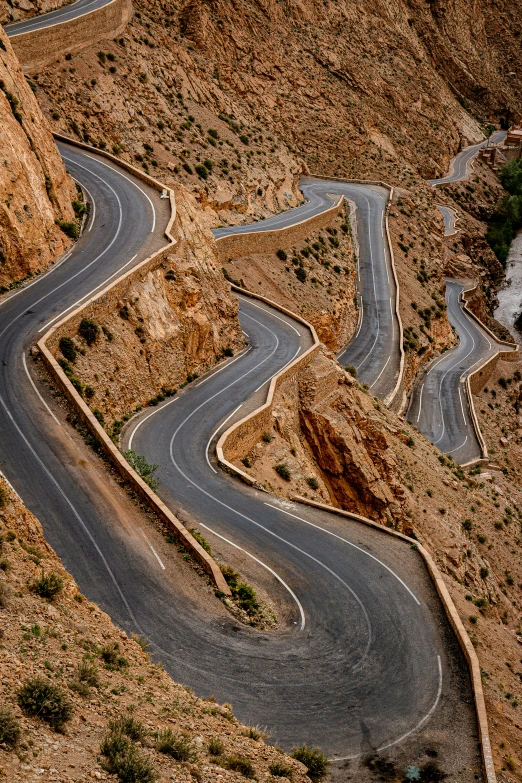 a road winding with some mountains in the background