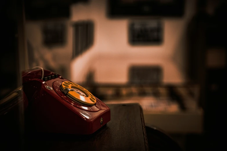 a red phone sitting on top of a black table