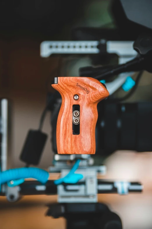 an unfinished piece of wood is sitting on a camera