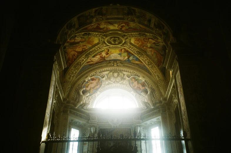 sunlight shines into the ceiling of an ornate building