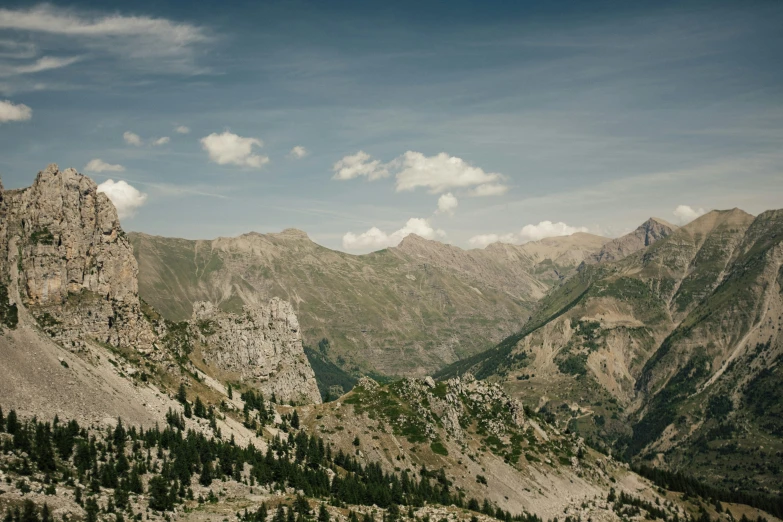 rocky mountain peaks on the side of a forest