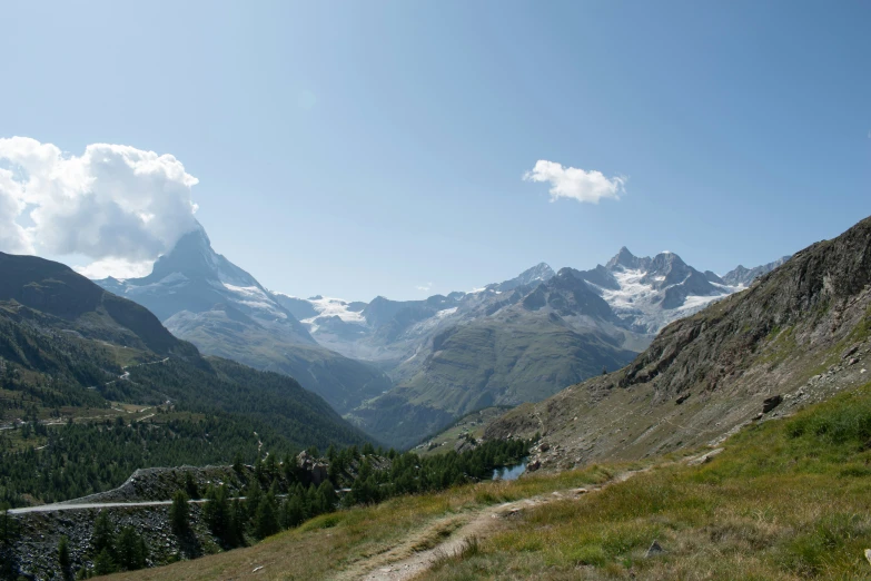 mountains and valleys rise above the water in the distance