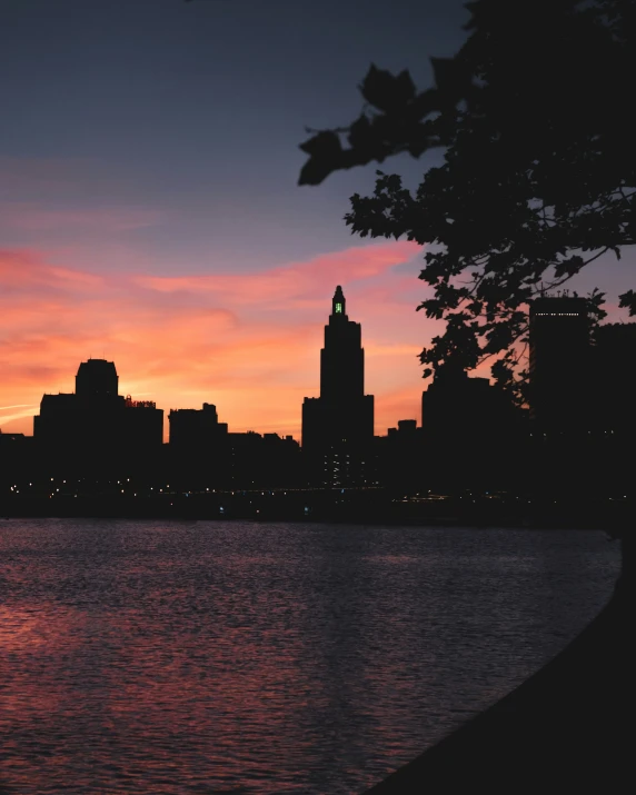 a city skyline with the sun going down