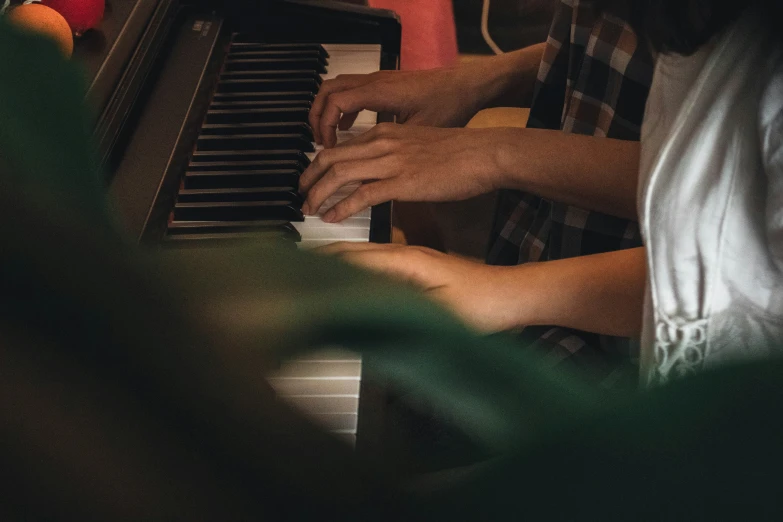 two people playing music and singing on an organ