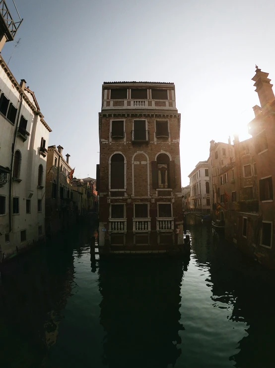 a waterway with boats on the water and tall buildings