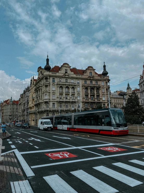 the bus is driving past buildings on the street