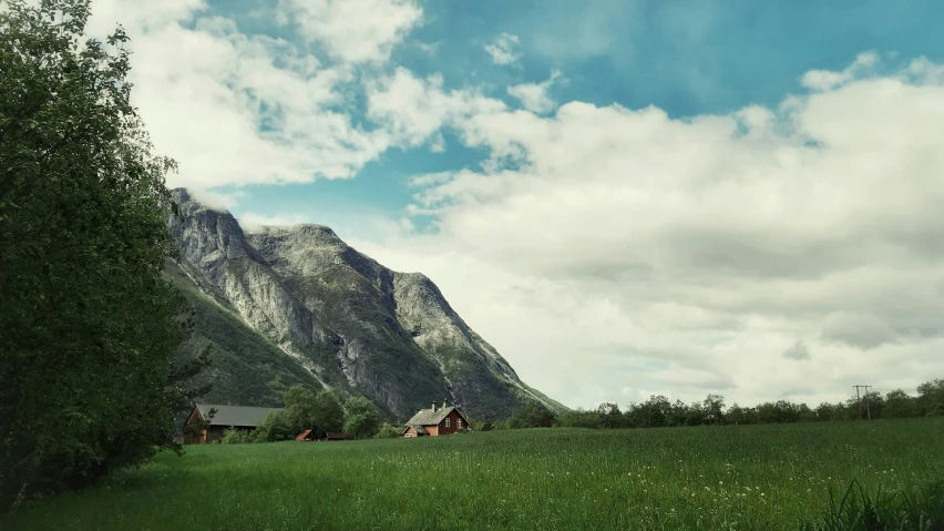 there is some clouds over the mountains and houses