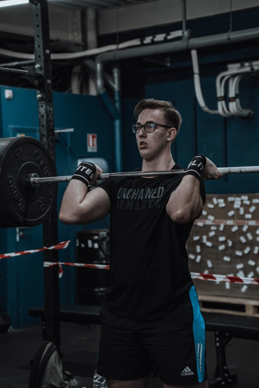 man using a barbell machine in the gym