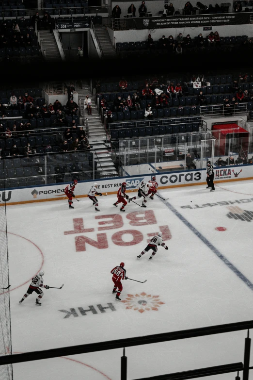 a hockey game in progress with the goal being hit by the puck