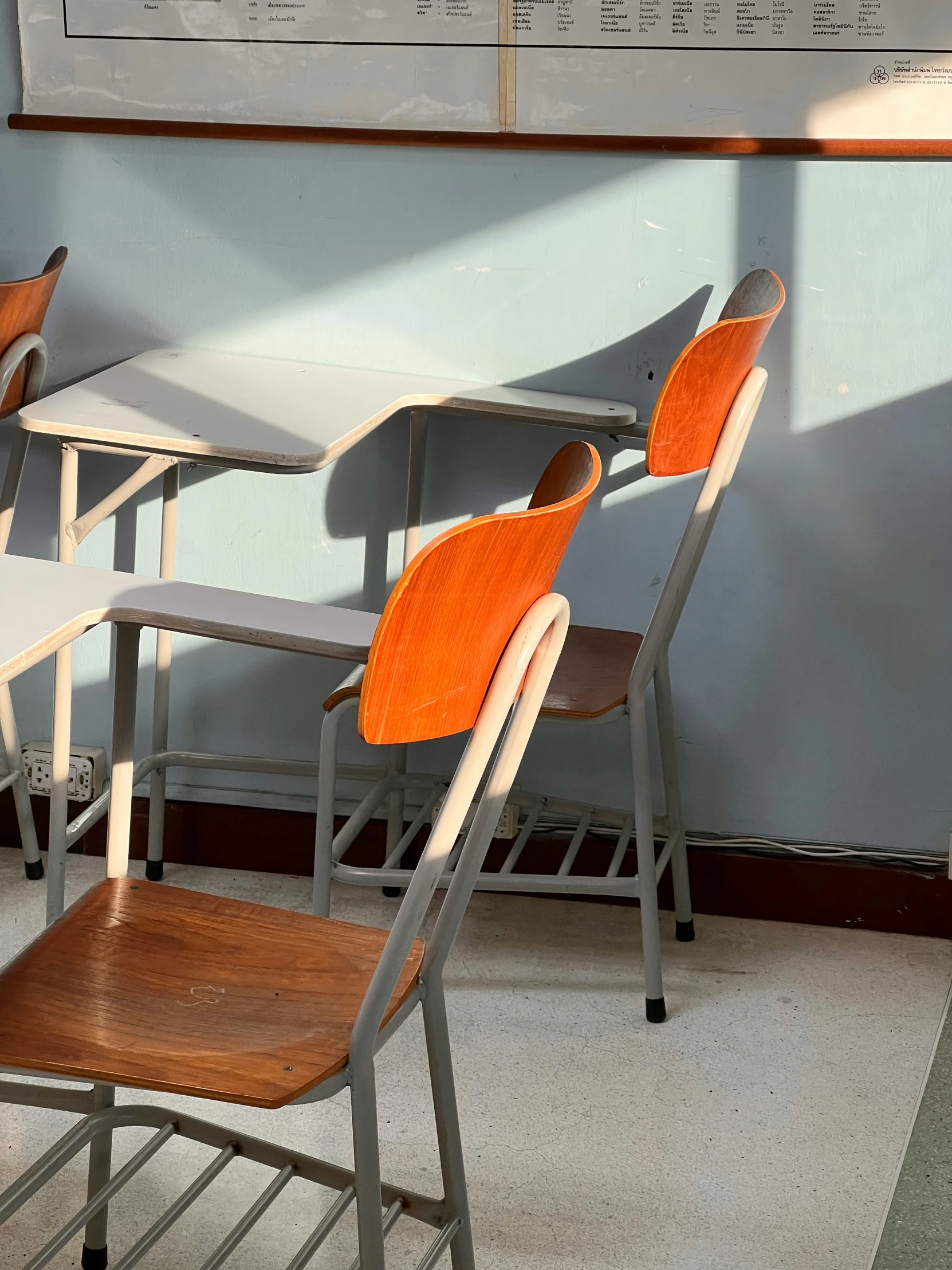 chairs line up in front of a chalk board