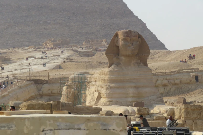 the egyptian pyramids stand near a crowd of people