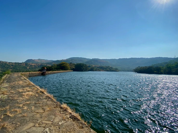 a person standing on a concrete platform by the water