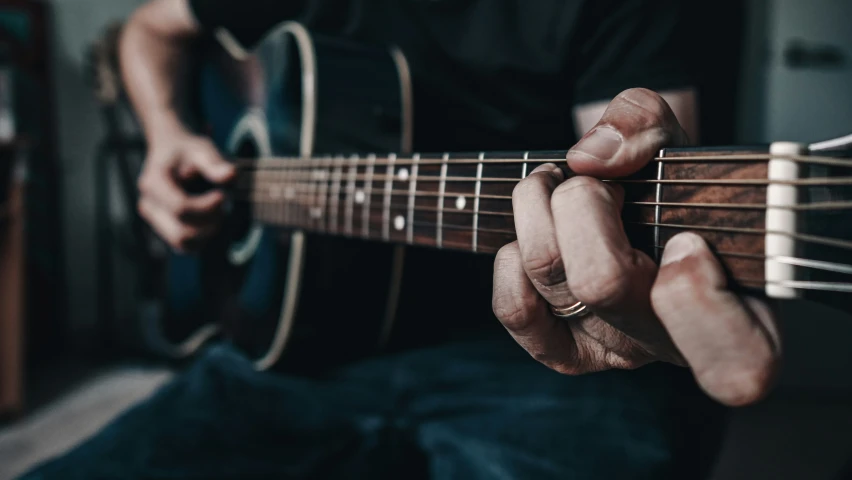 a man holding an electric guitar near his hands