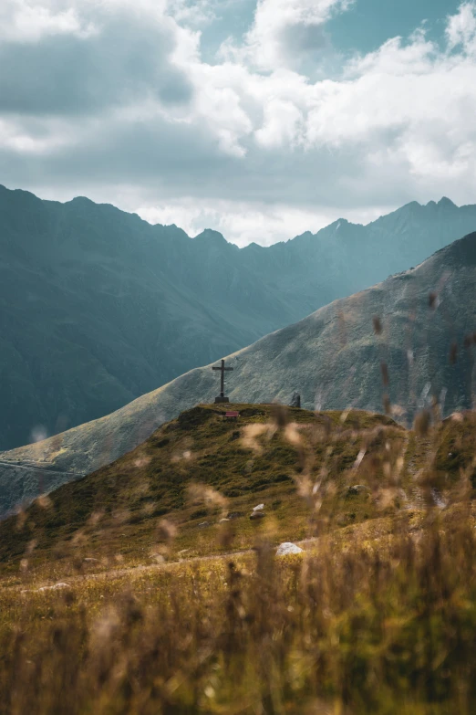 a lone person on top of a small hill