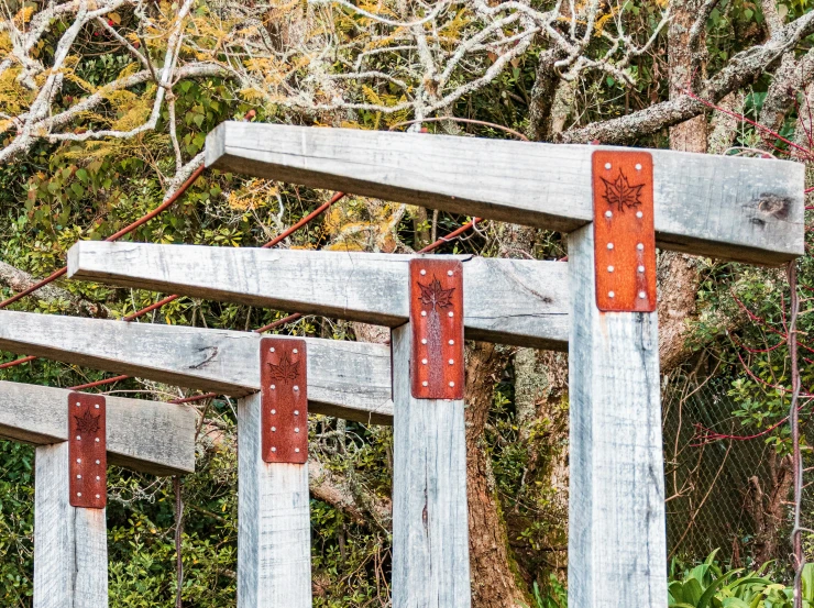 wood posts attached to a wooden bridge with orange painted arrows