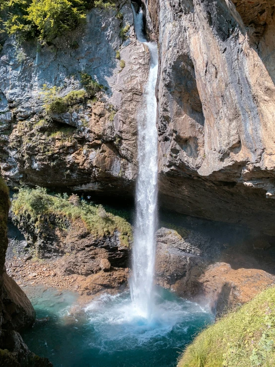 an image of a waterfall in a mountain side