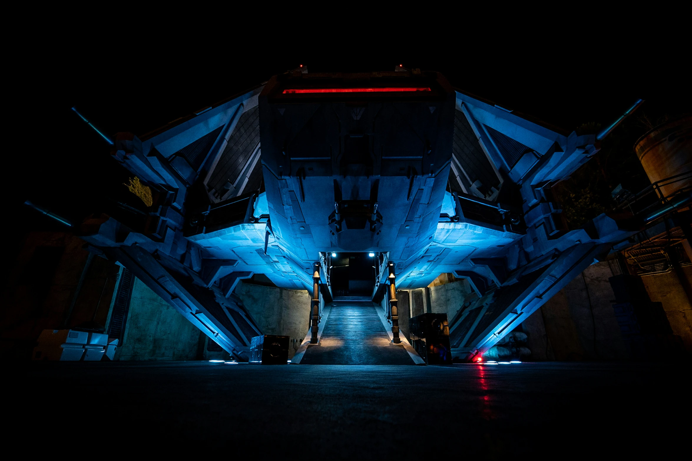 a tunnel in the dark with blue lights