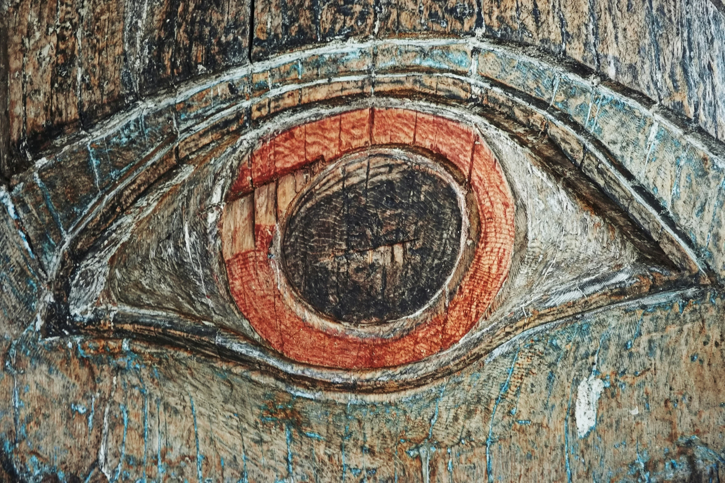 close up of wooden surface with a painted image of an eye