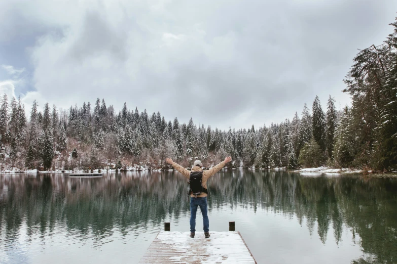 man walking off a dock while it snows
