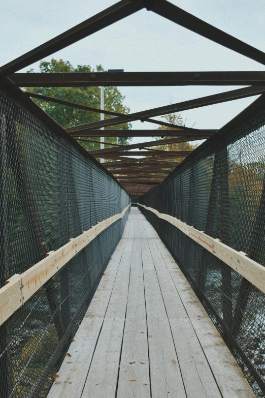 a bridge has a wooden plank leading across it