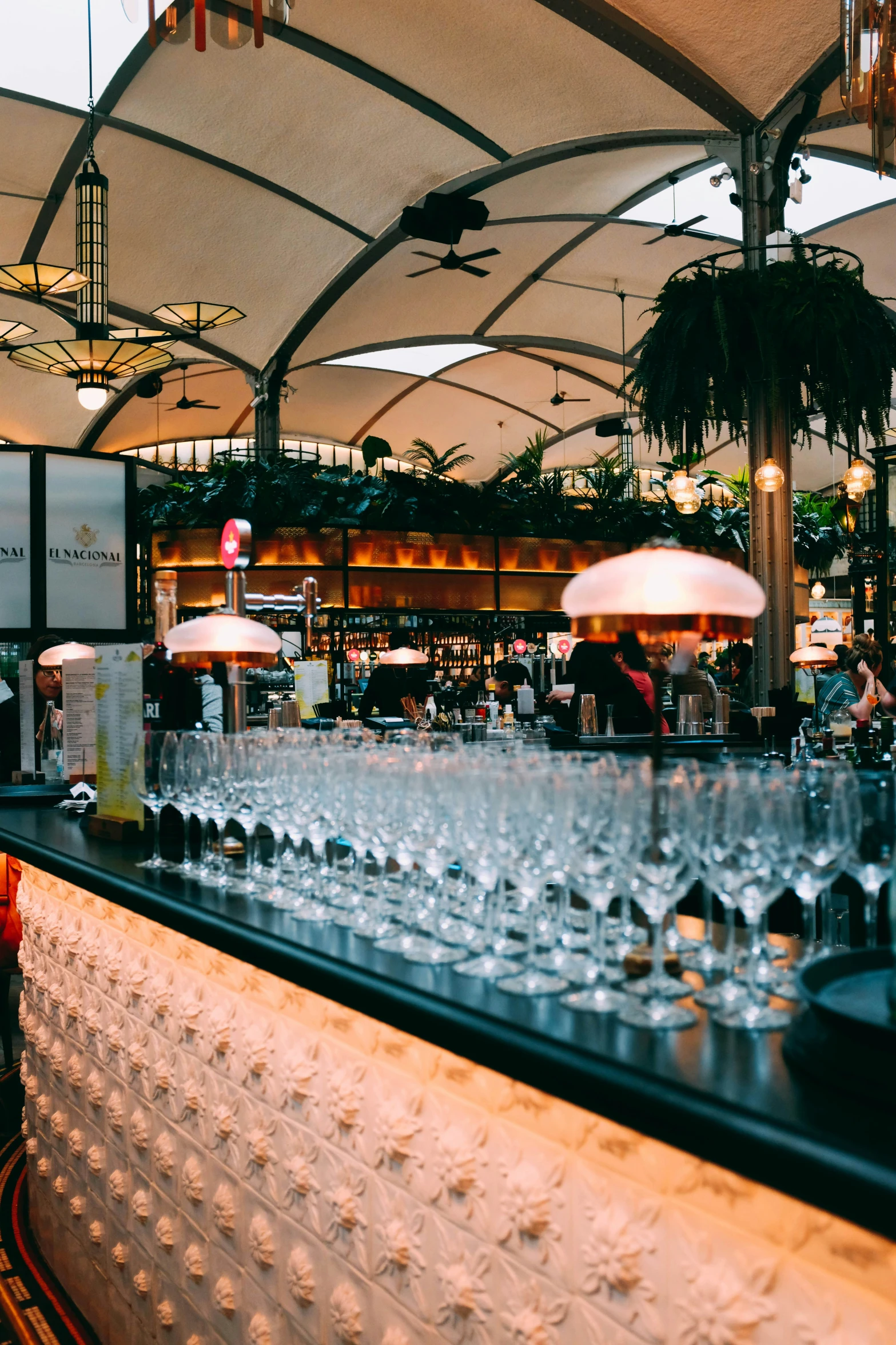 a restaurant that has many glasses on the bar