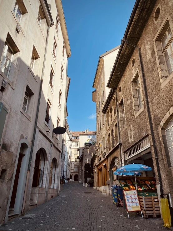 an alleyway with street vendors in an urban setting