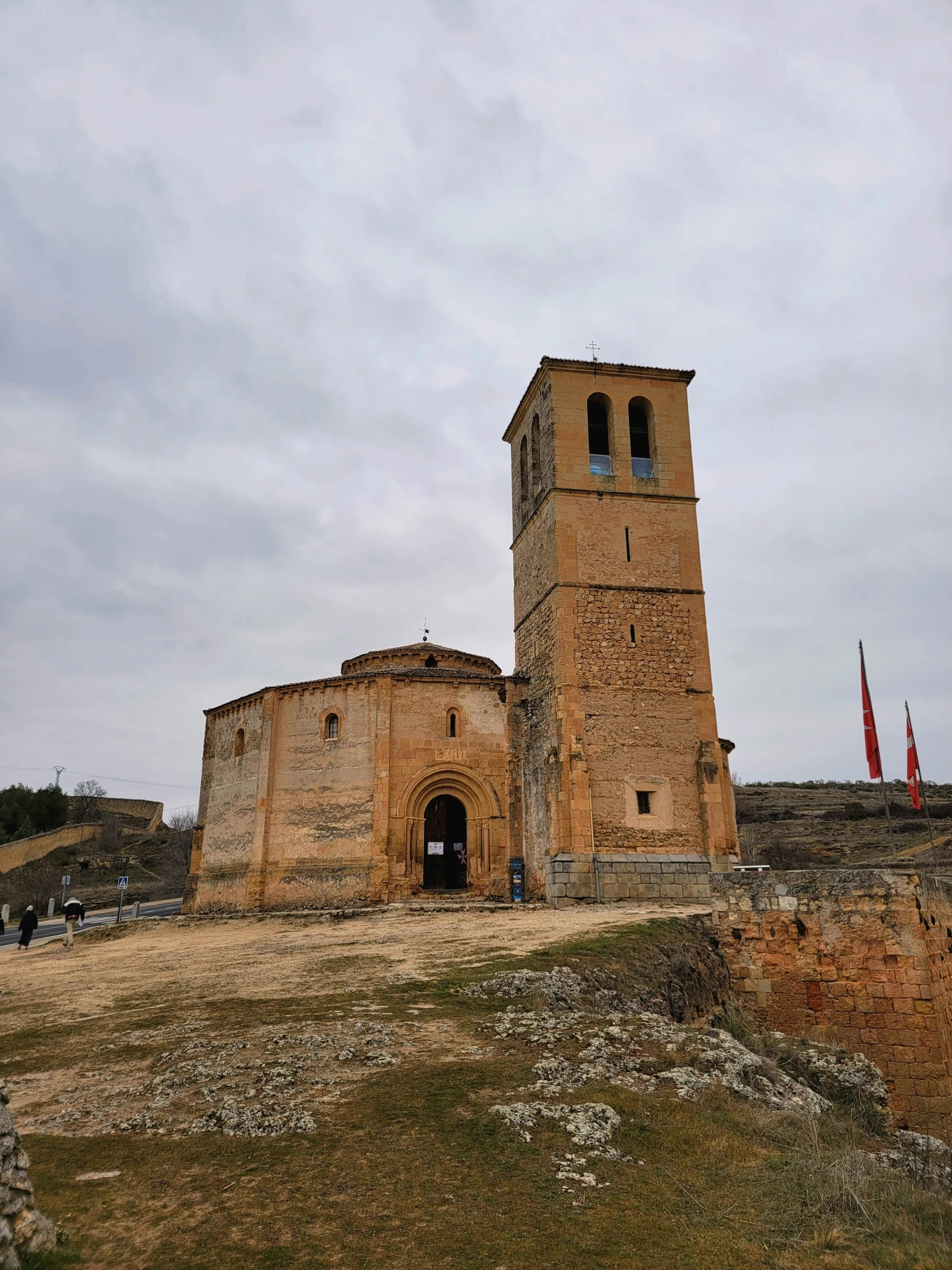 an old building with two towers stands on the side