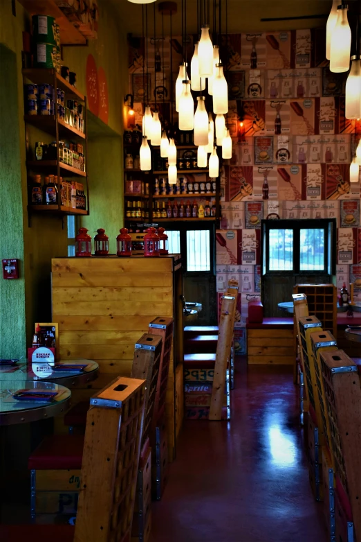 several wooden tables in a restaurant with various lighting fixtures