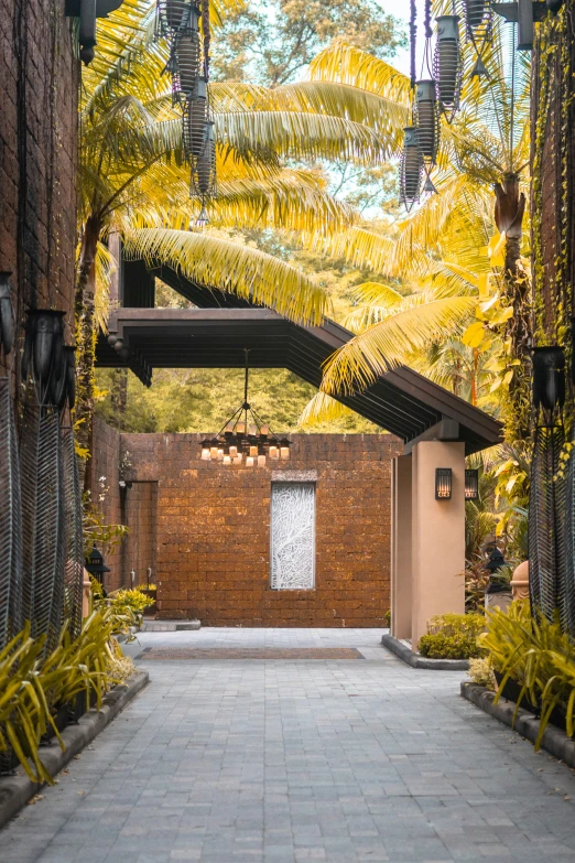 a stone pathway between two buildings, trees and landscaping