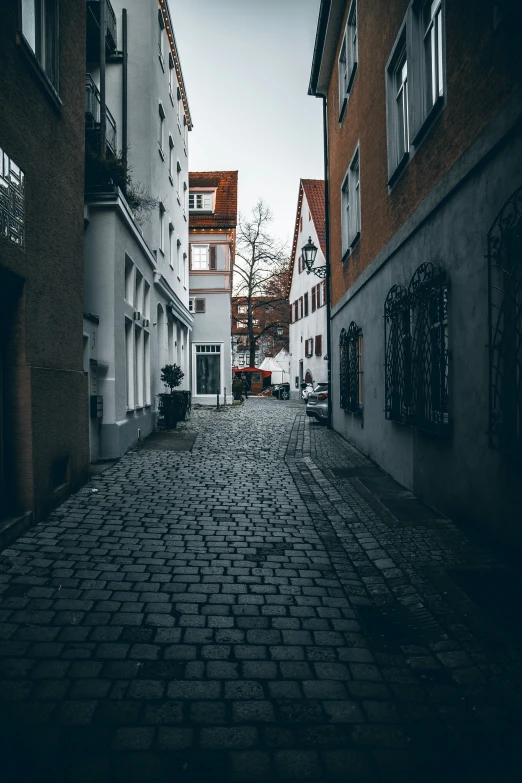 the cobblestones on the street have red building on them