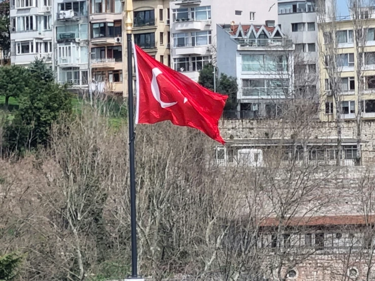 a turkish flag flying on the front of a building