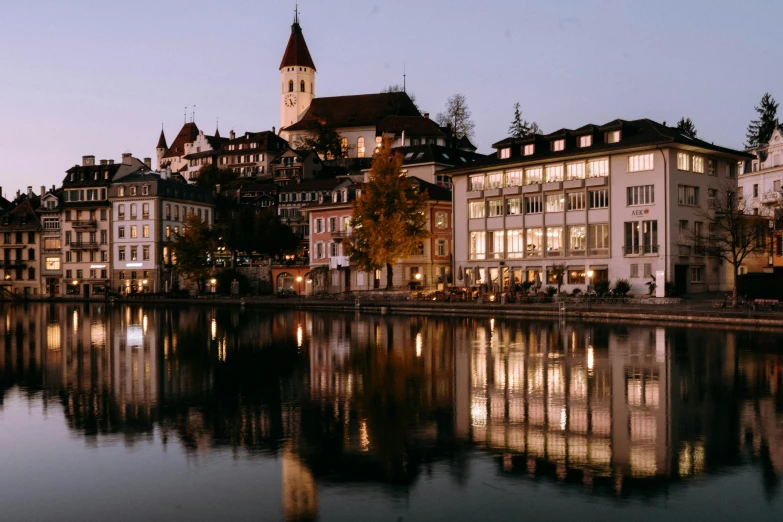 a large body of water with buildings and lights in it