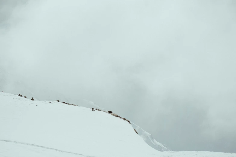 a lone man skiing down the snow covered hill